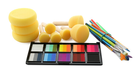 Bright face paint palette, brushes and sponges isolated on white