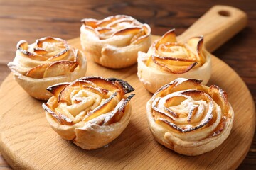 Freshly baked apple roses on table, closeup