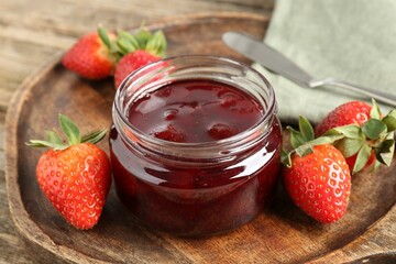 Delicious strawberry sauce and fresh berries on wooden table, closeup
