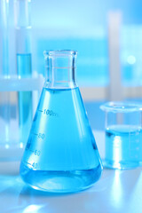 Laboratory glassware with liquid on table indoors