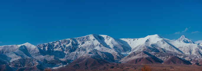 Panoramic view of snow-covered mountain peaks in Kyrgyzstan
