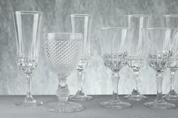 Many empty clean glasses on grey table