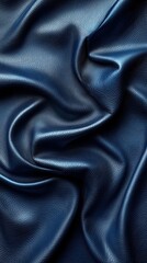 Fototapeta premium Smooth blue leather fabric drapes elegantly, showcasing texture and depth in warm lighting