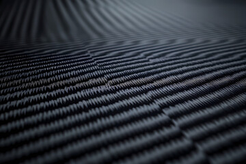 Black carbon fiber background, texture of dark gray fabric with a crosshatch pattern for a car interior or tech design