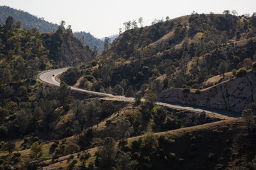 A windy road through mountains in California.