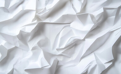 Obraz premium A close-up of crumpled white paper, creating an abstract, textured pattern with shadows.