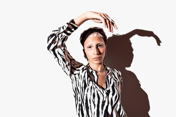 Fashion model in zebra print poses with dramatic shadow