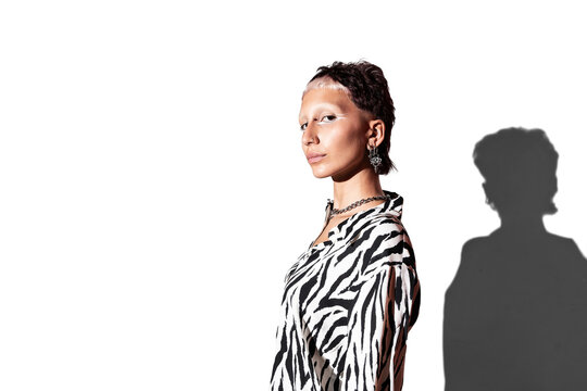 Fashion model in zebra print outfit with bold lighting in studio