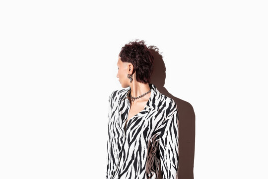 Fashion model in animal print attire with side profile pose