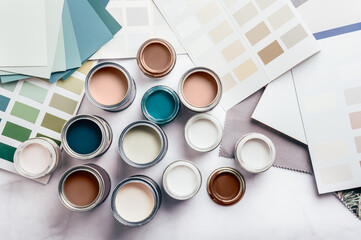 Tiny sample paint cans during house renovation, process of choosing paint for the walls, Mocha...