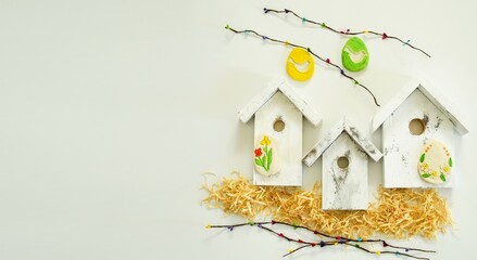 Spring holiday of bright Easter. DIY craft, wooden houses and colored eggs from salt dough. Home decor, holiday card.