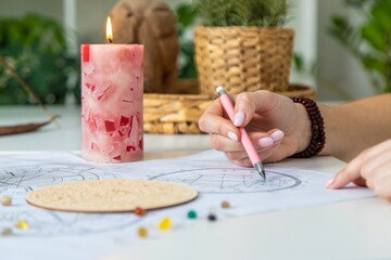 Woman astrologer draws a natal chart. Selective focus