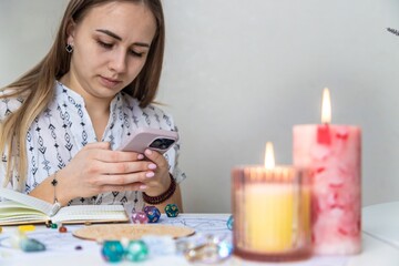 Modern Mystic Woman Practicing Divination with Candles and Tarot