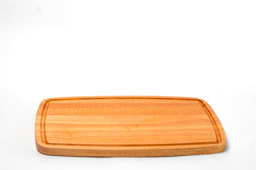 Empty rectangular wooden cutting board with juice groove, isolated on white background. Kitchen utensil for food preparation, chopping, and serving.