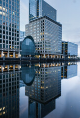 Reflections of corporate buildings in water, Canary Wharf, London