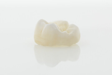 High-quality zirconia dental crown on white background. Dental ceramic crown professional dental lab