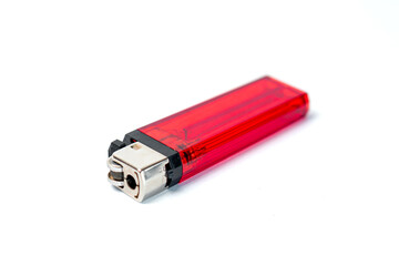 A close-up of a red lighter resting on a white background, highlighting its sleek design and functional features, ideal for various lighting needs.