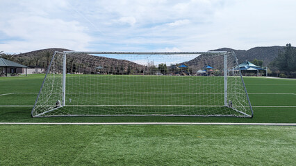 View down the length of a soccer field from behind one goal