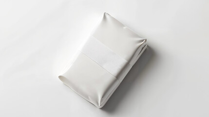 Obraz premium Unwrapped white package resting on a plain surface in a well-lit setting, showcasing minimalist design and simplicity