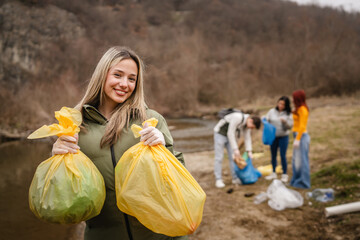 portrait of female teenager activist volunteer hold waste garbage