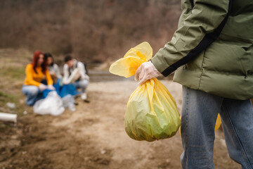 hands unknown caucasian teenagers picking up waste