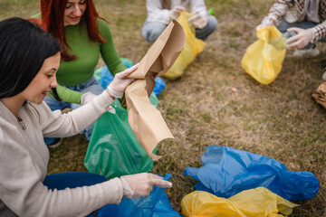 hands unknown caucasian teenagers picking up waste