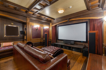 Classic home theater interior design. The room is decorated with wood and leather.