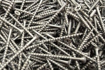 Scattered metal screws reflect construction and organization needs