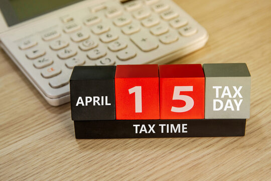Tax day concept. US tax due date, calendar block with the words "TAX DAY". tax deductions.