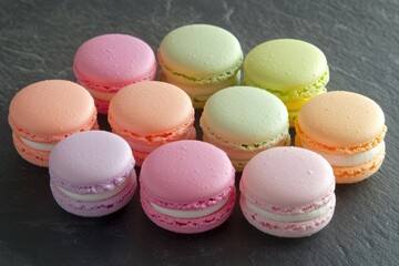 Obraz premium A delightful assortment of pastel-colored macarons, showcasing delicate textures and vibrant hues.