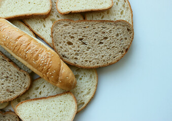 Pile of variety freshly baked bread in slices and sesame bun with copy space stock photo