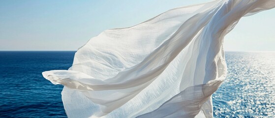 White fabric blowing gently over the vast and calming ocean