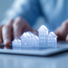 Real Estate Concept with House Models on Tablet