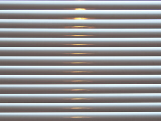 Obraz premium Beige Venetian blinds with sunlight closeup abstract