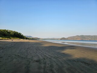 Costa Rican beach at sunset with mountain views