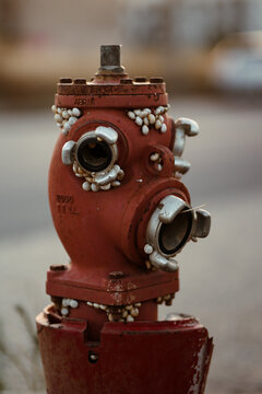 Aged Red Fire Hydrant Covered in Barnacles and Signs of Decay