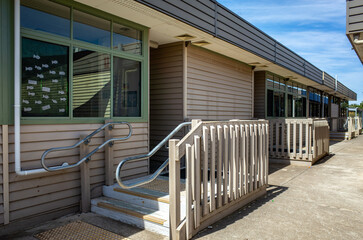 a row of weatherboard classroom buildings at a primary school campus in Australia. The old-fashion, modest, and functional educational facility in a public elementary school.
