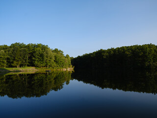 Glass like smooth surface reflections of sunset over Boley Lake in Wedst Virginia