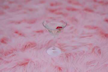 Delicate Cocktail on Plush Pink Fur Background. pink fur texture