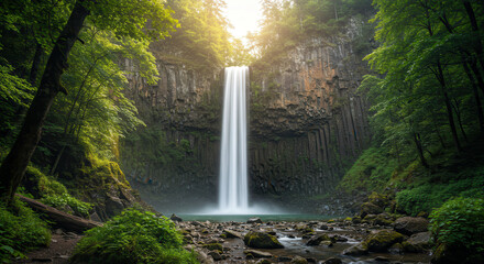 Majestic Forest Waterfall Flowing Over Rocky Terrain with Lush Greenery and Sunlit Tranquility
