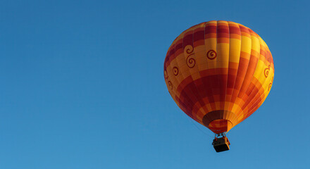 Naklejka premium Colorful Hot Air Balloon Soaring in Blue Sky During Sunny Day Aerial Flight Adventure