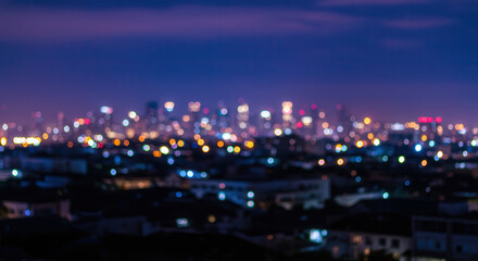 Blurred Urban Night Cityscape with Illuminated Skyline and Bokeh Lights