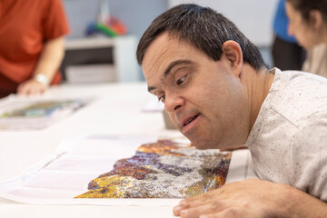 Man with Down Syndrome Creating a Colorful Mosaic Artwork