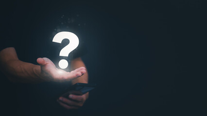 A businessman shows a question mark on his palm to represent a problem or asks a question to solve a problem, as well as management concepts, progress, or ideas about success.