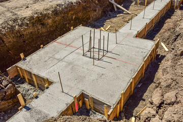 Fresh concrete in wood forms with rerod, will be footings for new commercial building to be...