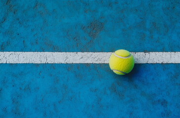 Sports Photography: Tennis Ball on the Line – A perfectly positioned tennis ball touching the boundary line, symbolizing precision, accuracy, and the thrill of competition.

