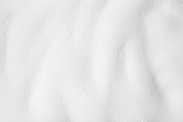 White fluffy foam as background, top view
