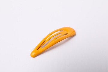 One orange hair clip on white background