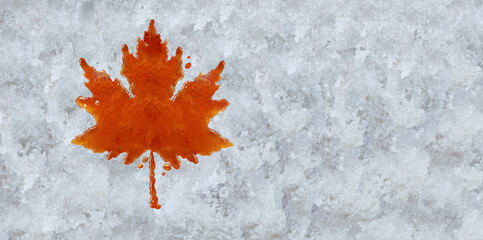 Canadian Maple Syrup shaped as a leaf representing authentic boiled sweet tree sap on snow as a traditional spring food culture from Quebec Ontario and Eastern Canada produced in a sugar shack.