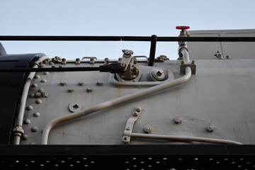 Top of boiler on steam locomotive. Several lines and valves.